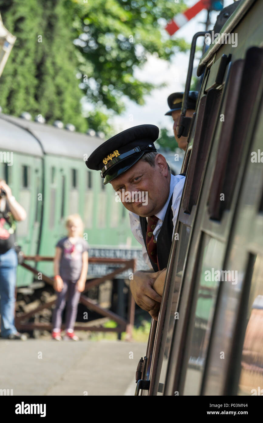 Front view close up of train conductor (guard) in uniform, on vintage