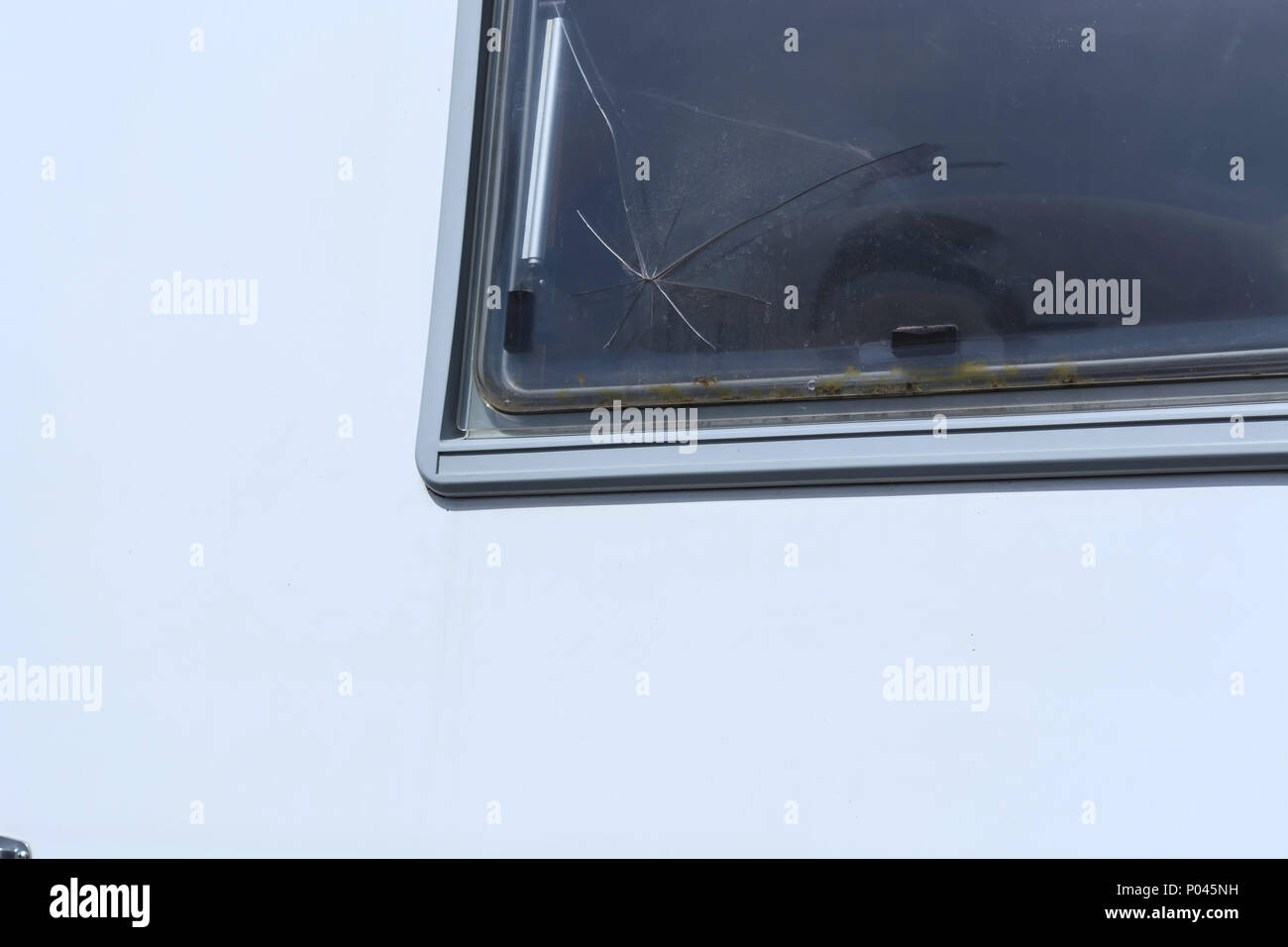 Broken glass, cracks, bullet holes on glass Stock Photo