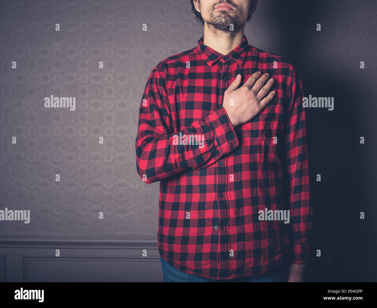 A young man in a red shirt is swearing allegiance Stock Photo