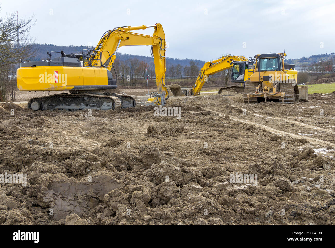 excavators at a loamy construction site Stock Photo - Alamy