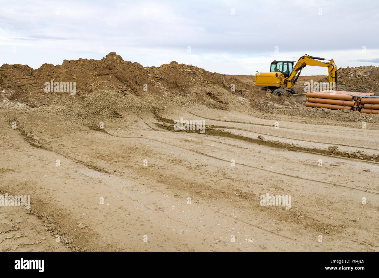 excavator at a loamy construction site Stock Photo - Alamy