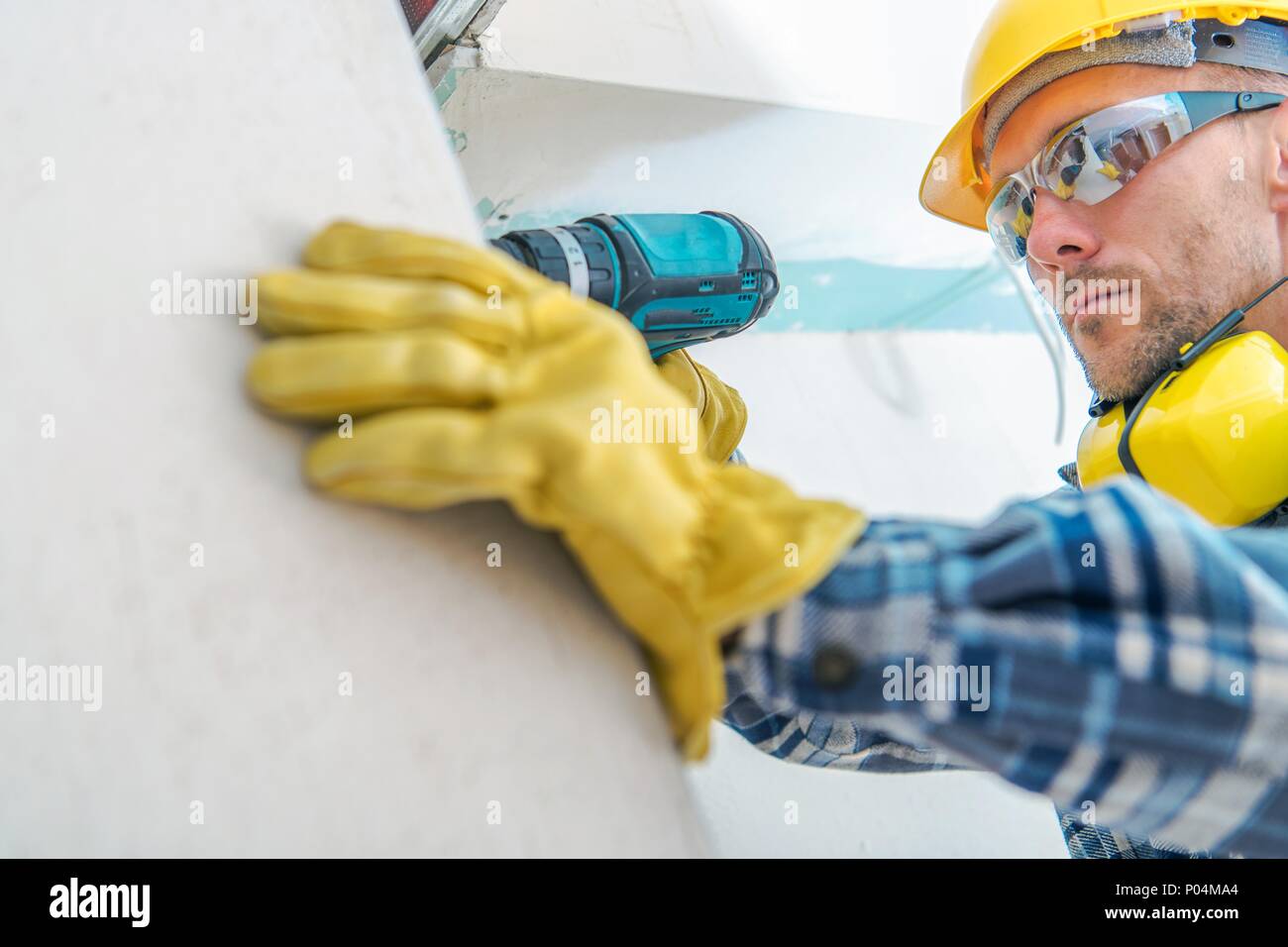 Contractor Remodeling Job. Caucasian Worker with Cordless Driller