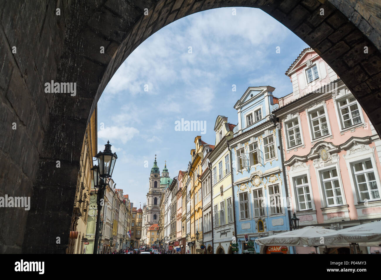 Lovely view on the Prague architecture from under the arch of Charles Bridge Stock Photo