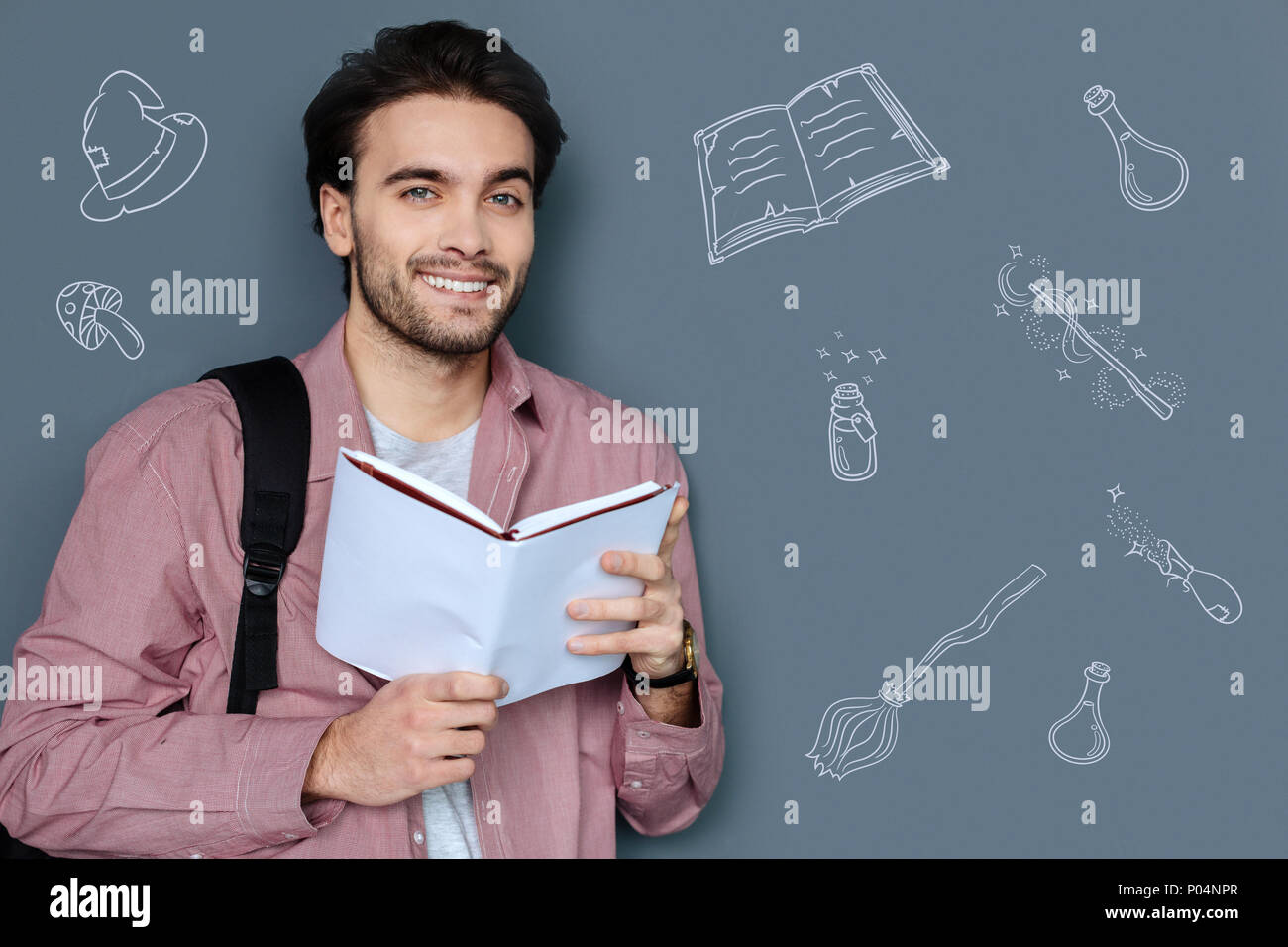 Dreamy man reading fantasy books and dreaming about witches and wizards Stock Photo