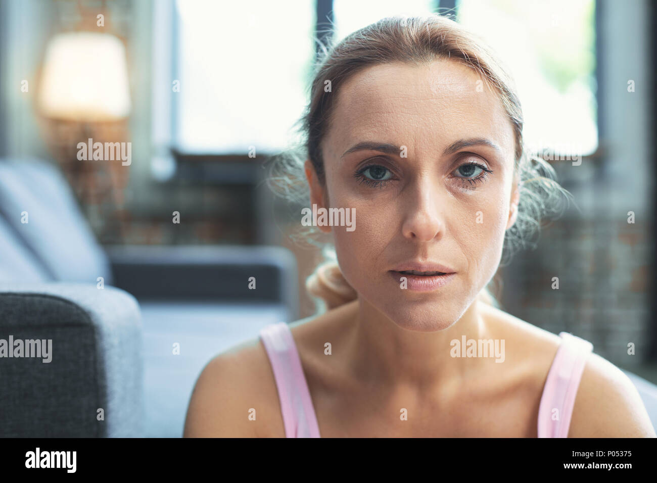 Unhappy mature woman staring at camera Stock Photo