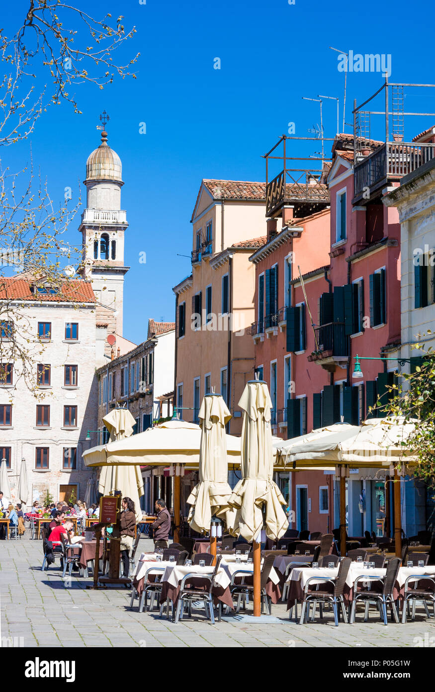 VENICE, ITALY - MARCH 28, 2015: Spring cafe open-air in Venice. Each year 20 million tourists visit Venice Stock Photo
