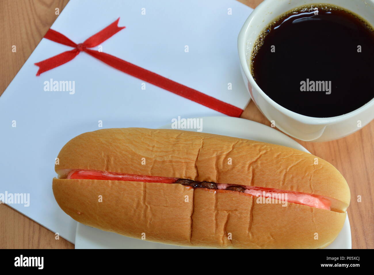 hot dog bread filled strawberry cream raisin and black coffee Stock