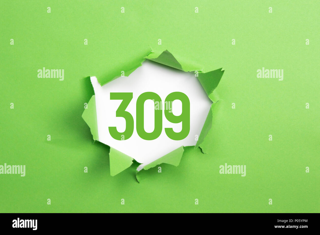 Green Number 309 on green paper background Stock Photo