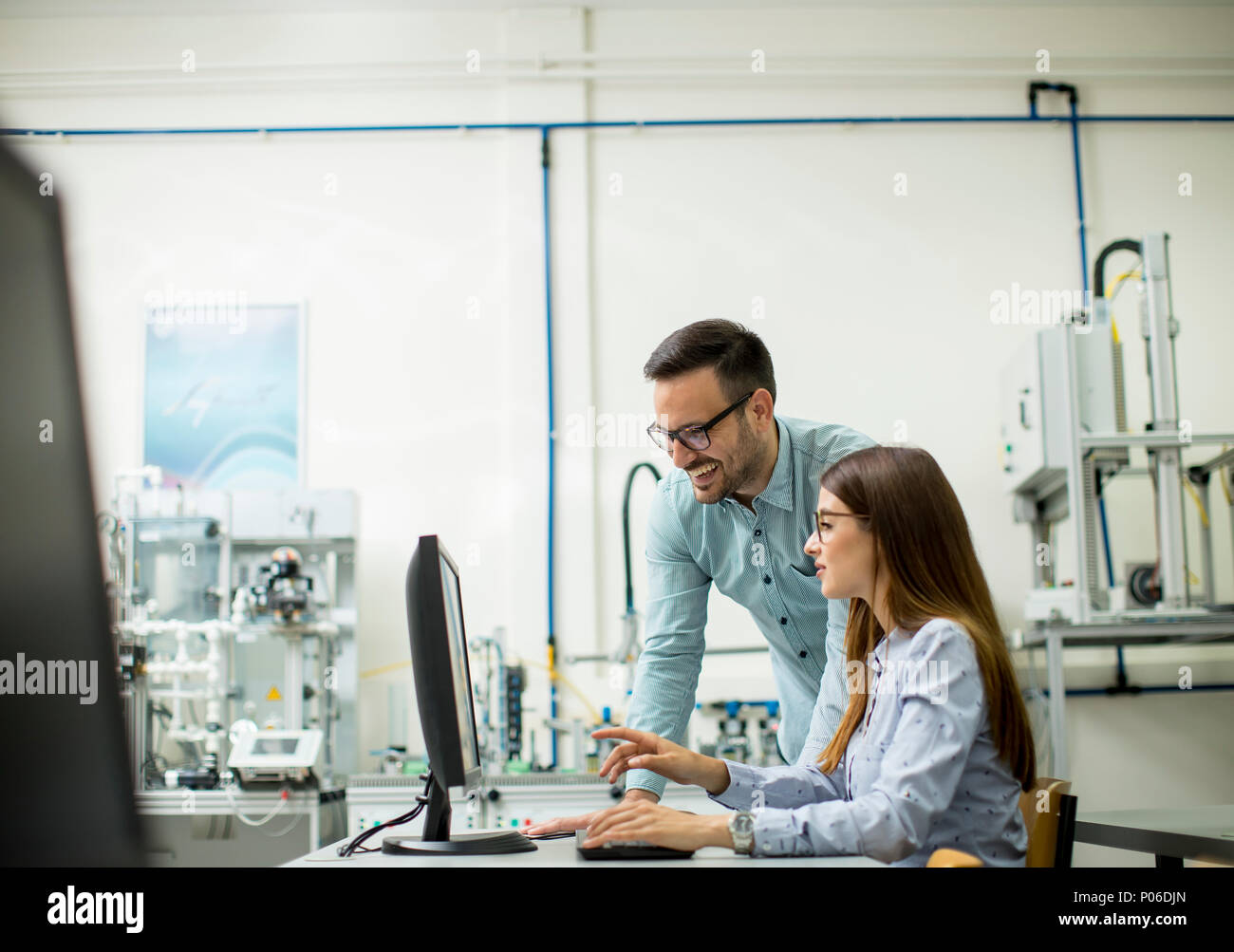Side view of focused students using desktop pc in classroom at
