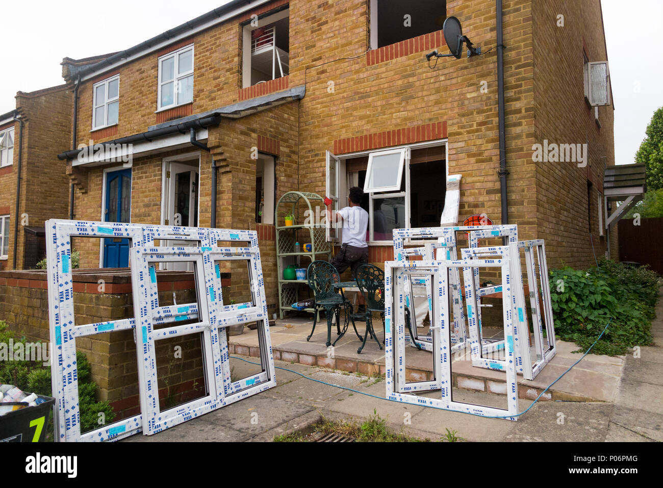 a Buy to let property / maisonette house having new replacement uPVC  / u PVC windows fitted / installed and old wooden window removed. UK (99) Stock Photo