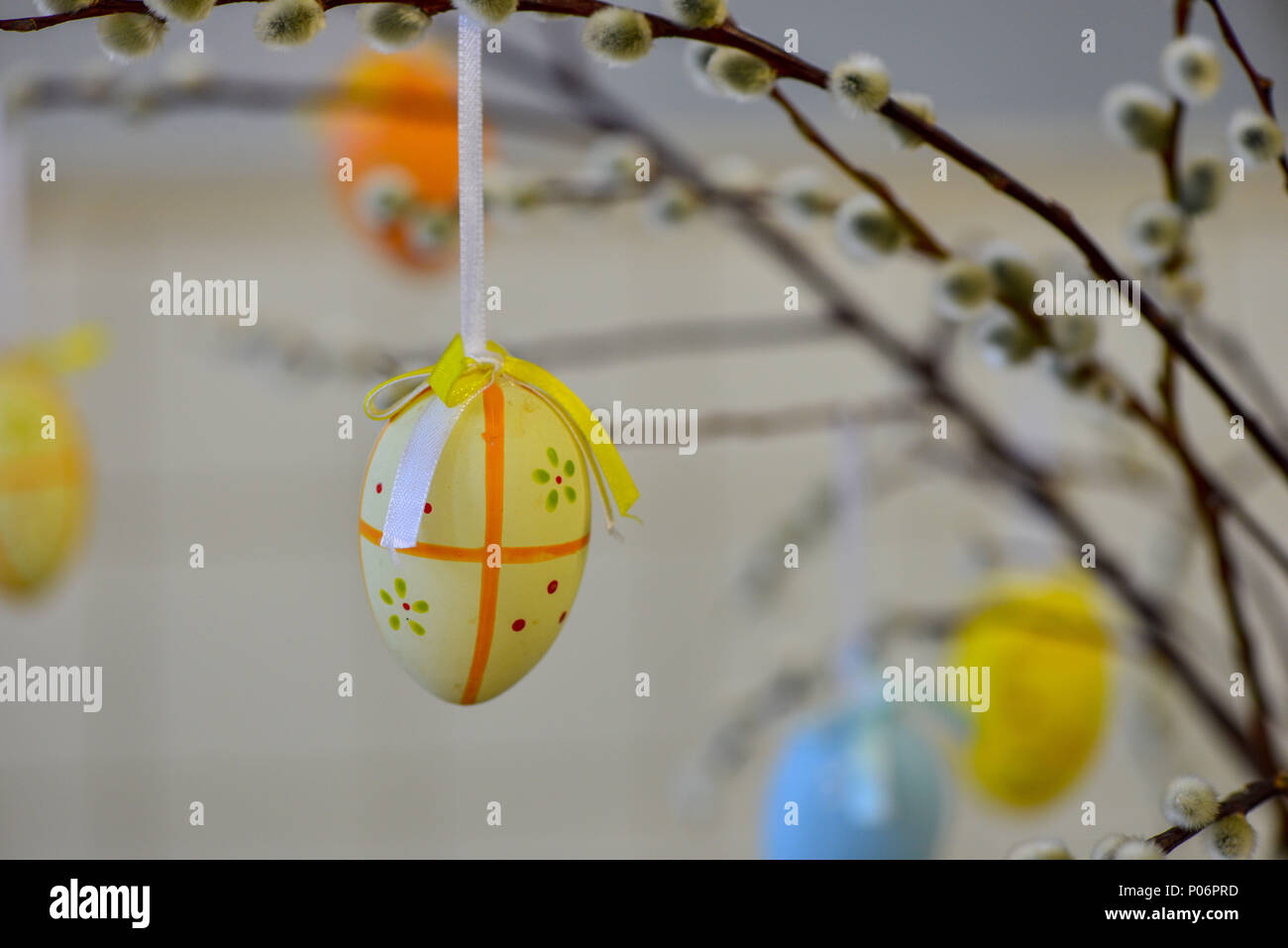 Easter eggs hanging from the willow branches. Easter decorations. Easter holidays. Stock Photo