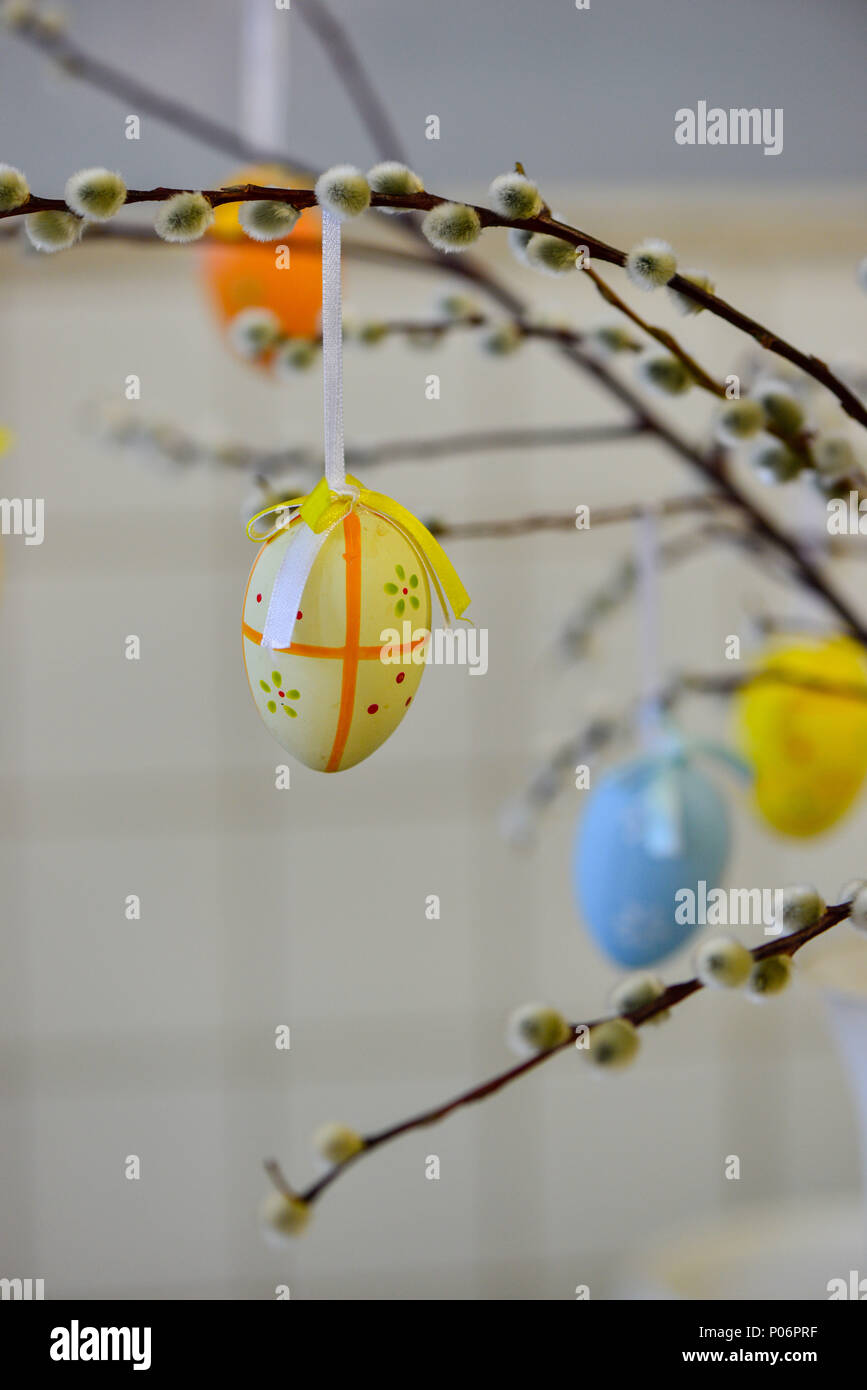 Easter eggs hanging from the willow branches. Easter decorations. Easter holidays. Stock Photo