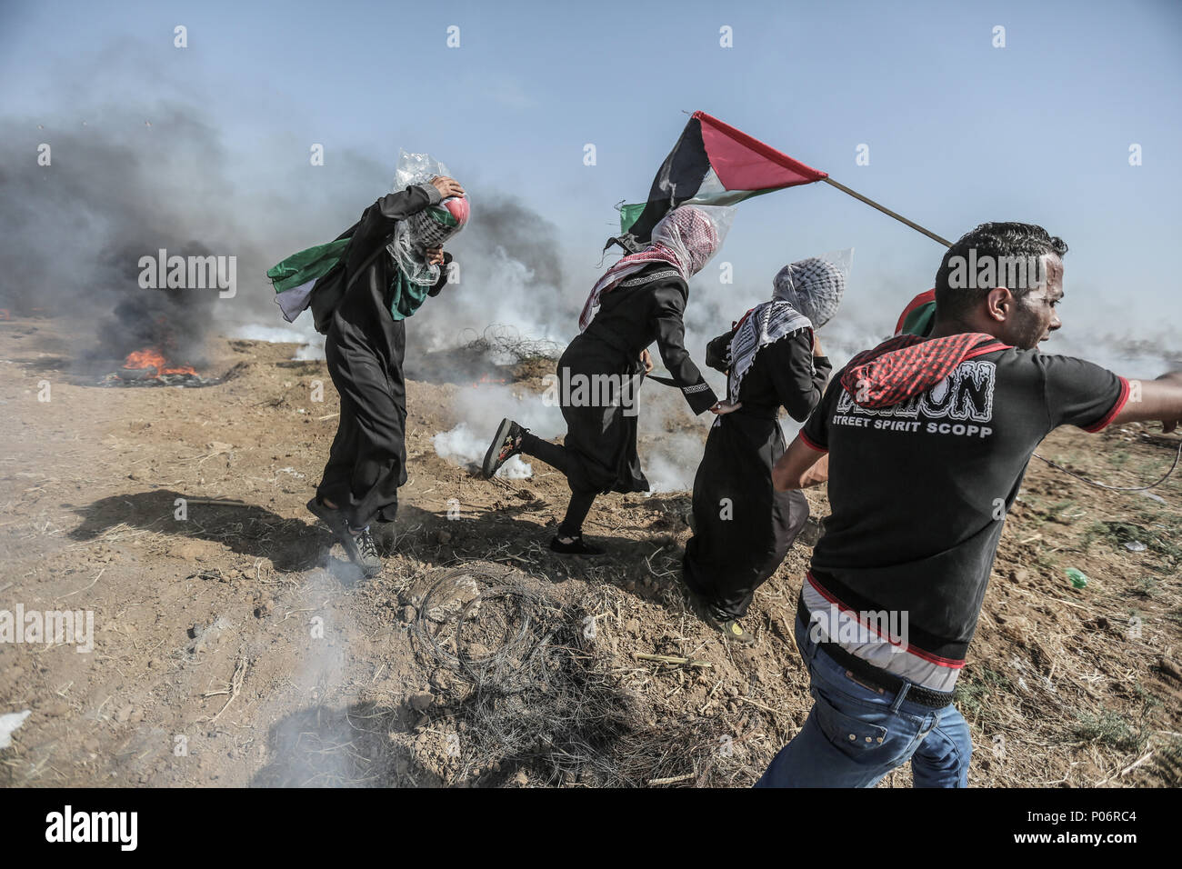 Female Palestinian protesters have plastic bags over their heads as protection from teargas fired by Israeli forces during clashes at a demonstration marking Jerusalem Day (Al Quds Day) at the Israli-Gaza border east of Gaza City, Gaza Strip, 08 June 2018. Photo: Wissam Nassar/dpa Stock Photo