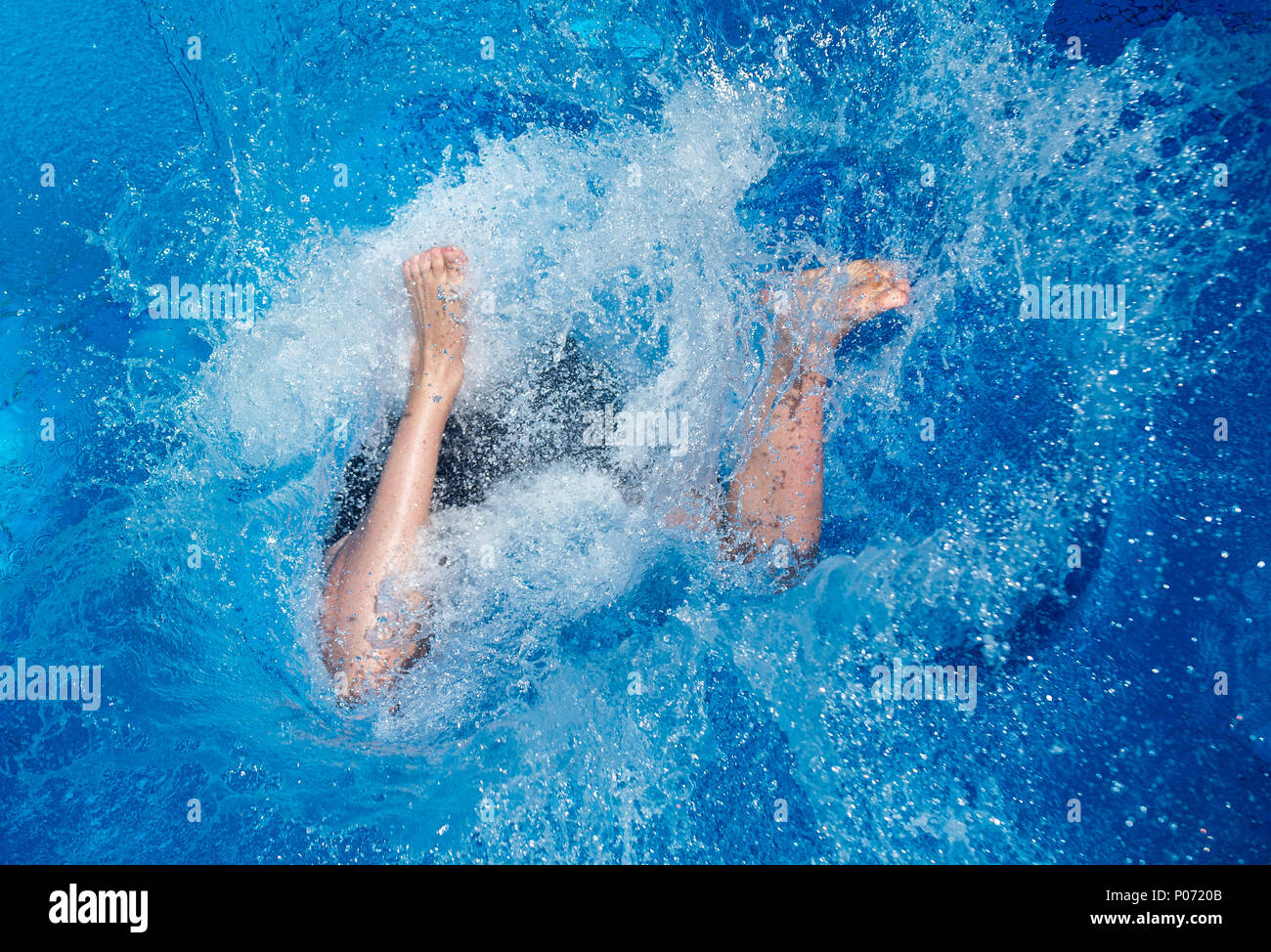 07 June 2018, Germany, Hanover: A youth jumps from a diving tower at the Lister Freibad open air swimming pool. Photo: Hauke-Christian Dittrich/dpa Stock Photo