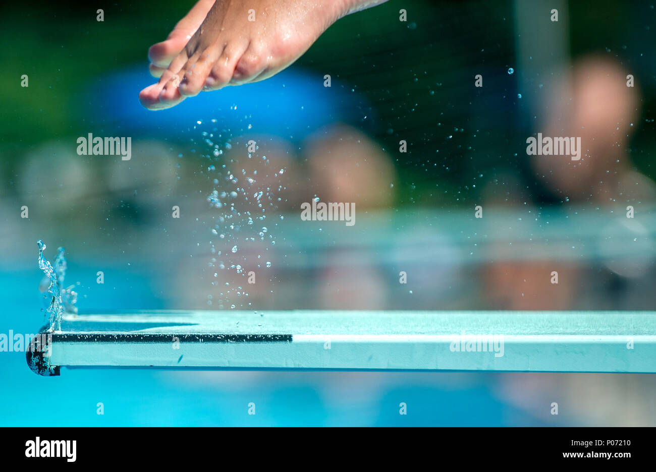 07 June 2018, Germany, Hanover: A youth jumps from a diving board at the Lister Freibad open air swimming pool. Photo: Hauke-Christian Dittrich/dpa Stock Photo