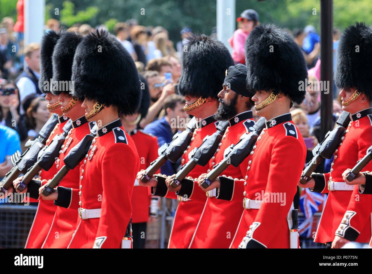 The Mall, London, UK, 9th June 2018. A Sikh soldier, Guardsman Charanpreet Singh Lall (middle), is the first to wear a turban (dastar) at Trooping the Colour. The Sovereign's birthday is officially celebrated by the ceremony of Trooping the Colour, the Queen's Birthday Parade. Troops from the  Household Division, overall 1400 officers and soldiers are on parade, together with two hundred horses; over four hundred musicians from ten bands and corps of drums. Stock Photo