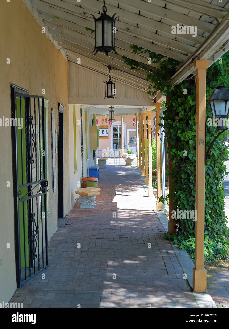 Storefront walkway with overhang with vines in Old Town Albuquerque Stock Photo