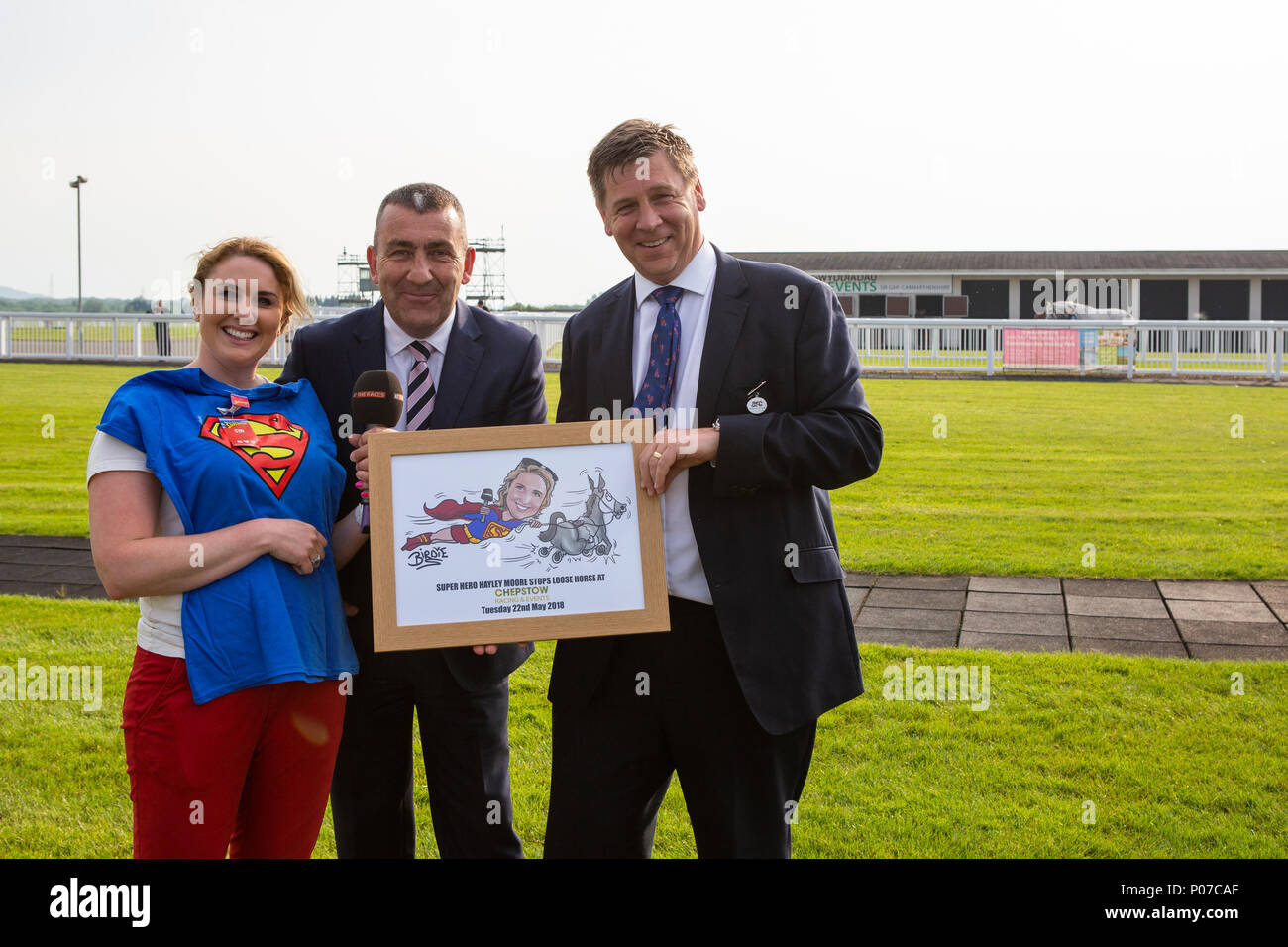 Phil Bell (centre) and Mark Spincer of ARC present a picture and t-shirt to At the Races reporter Hayley Moore Stock Photo