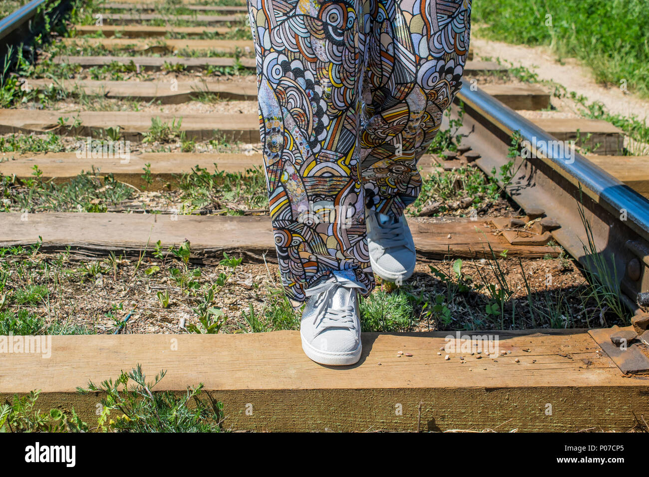 girl walking on wooden railway sleepers home, rails sleepers Stock Photo