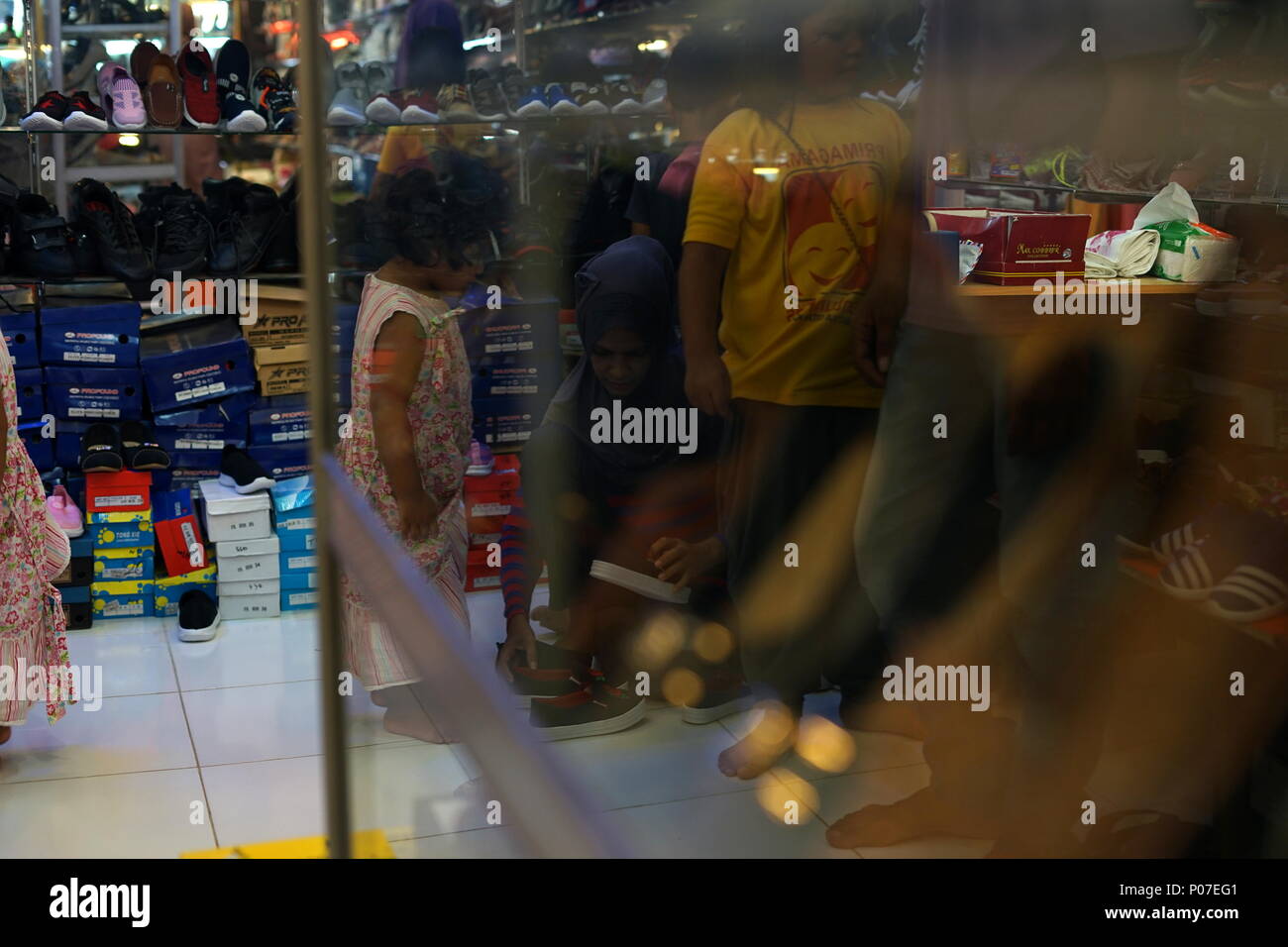 Family Shopping for Shoes for celebration of Hari Raya Aidilfitri (Eid alFitr) at a street