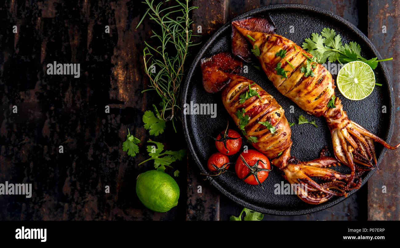 Korean BBQ squid calamary and ingredients on dark background