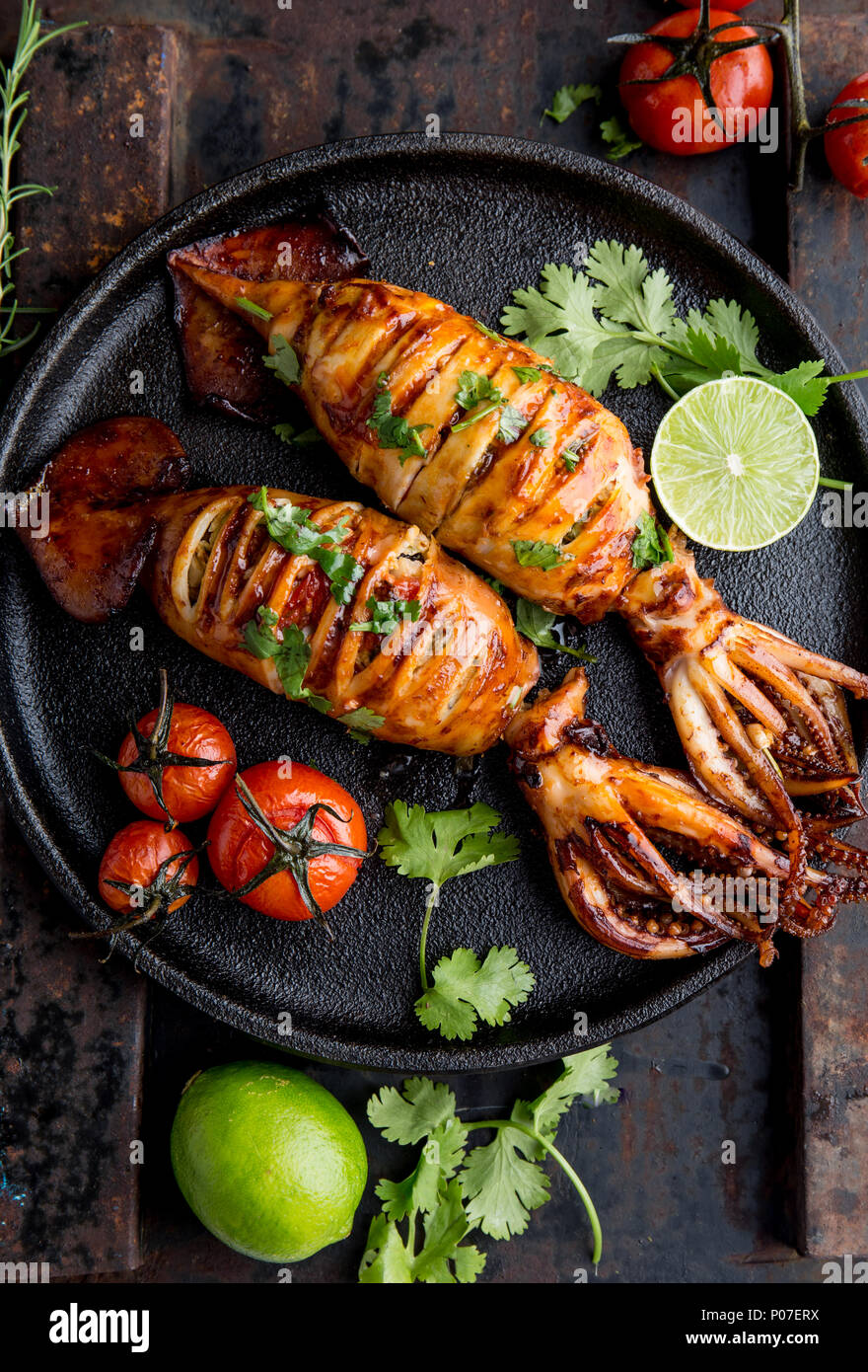 Korean BBQ squid calamary and ingredients on dark background