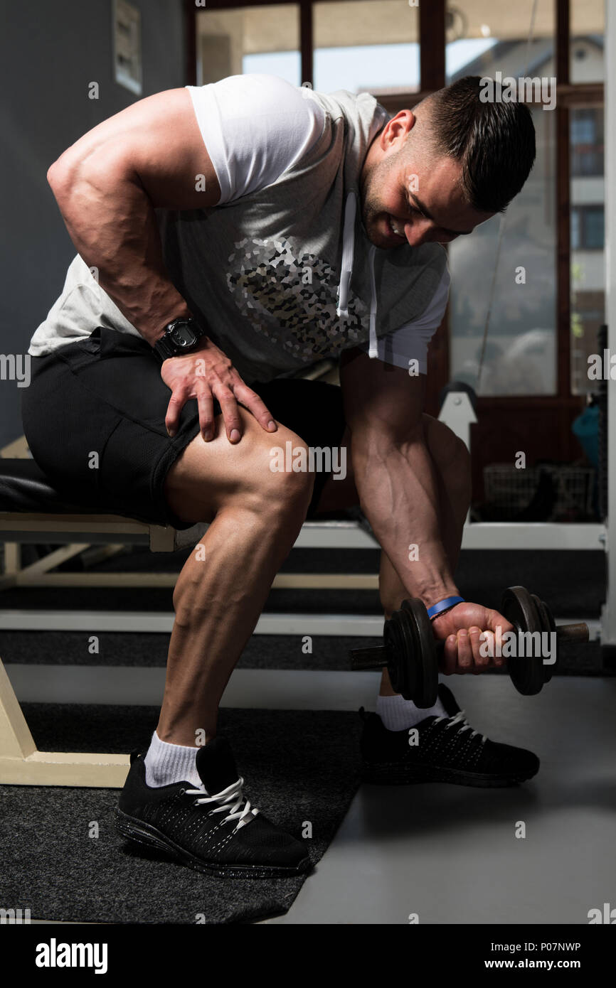 Man Working Out Biceps In A Gym - Dumbbell Concentration Curls Stock ...