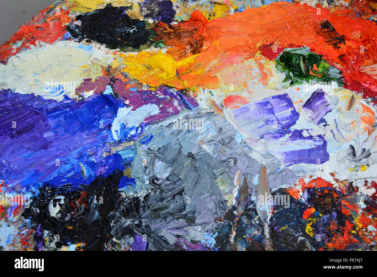 A painter's palette in his with tools Stock Photo Alamy