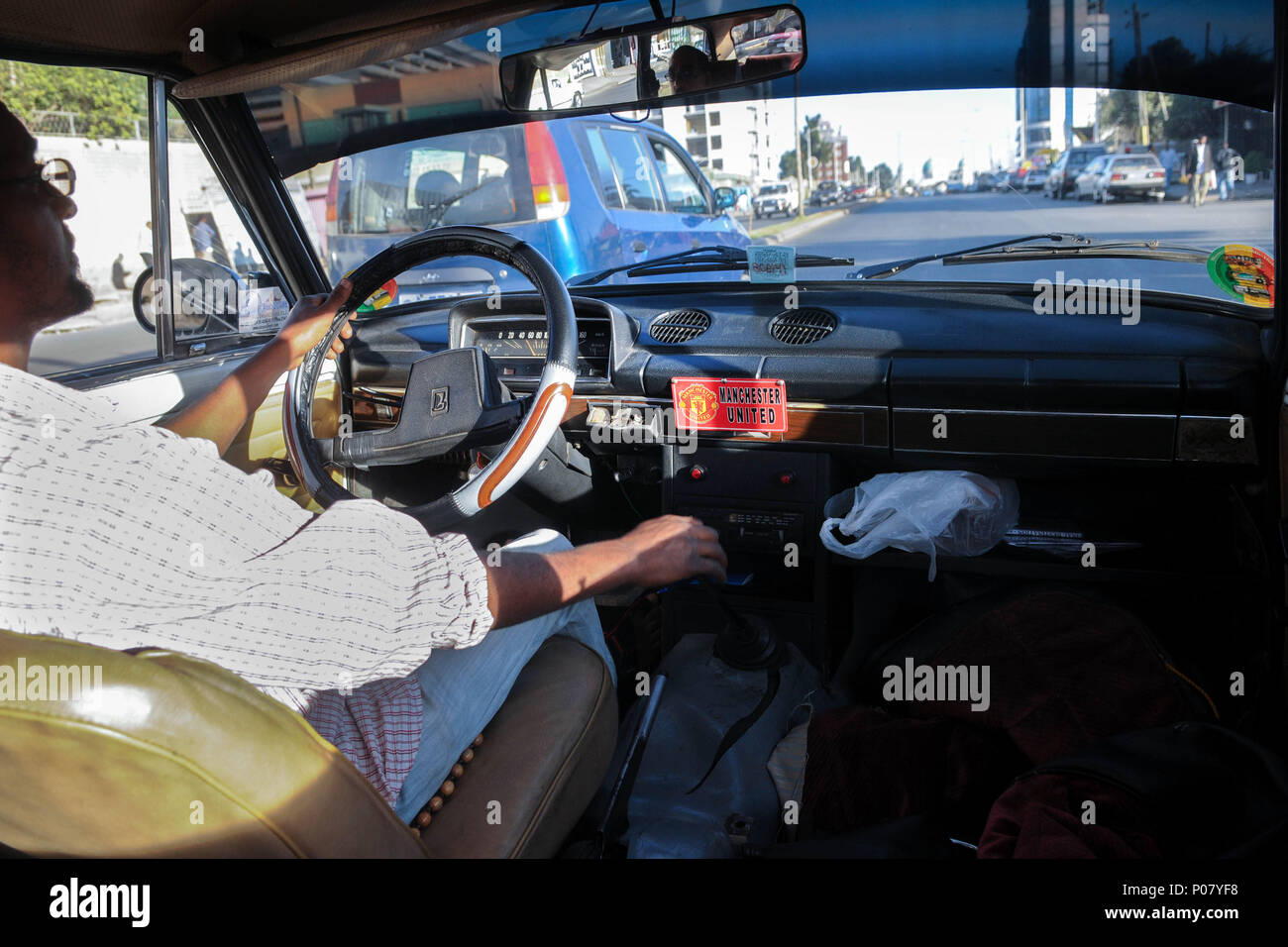 Manchester United fan driving a taxi in Addis Ababa, Ethiopia, Africa Stock Photo