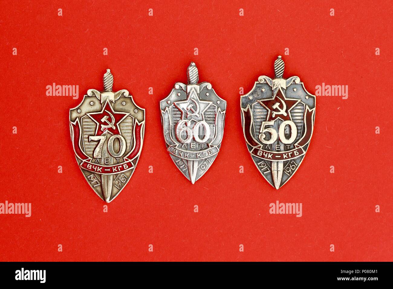 Three Russian KGB  badges commemorating 50, 60 and 70 years anniversaries. Stock Photo