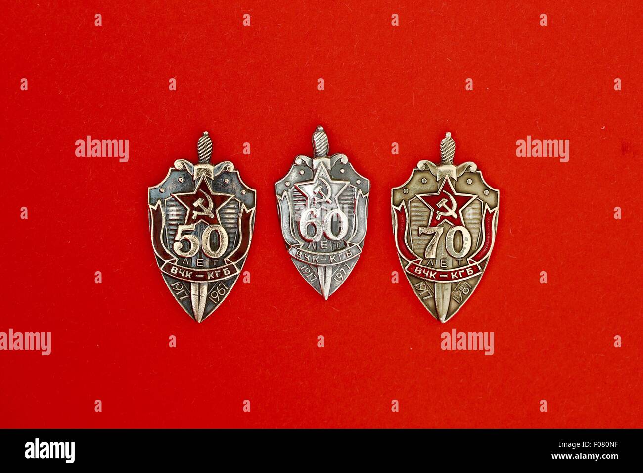 Three Russian KGB  badges commemorating 50, 60 and 70 years anniversaries. Stock Photo
