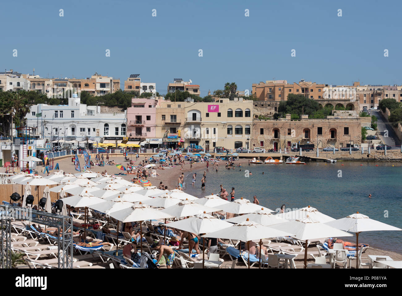 Beach in Malta sunny people swimming and sunbathing Stock Photo