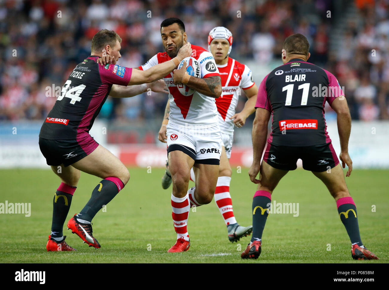 St Helens' Zeb Taia (centre) is tackled by Hull KR's Danny Tickle (left) and Maurice Blair during the Betfred Super League match at the Totally Wicked Stadium, St Helens. Stock Photo