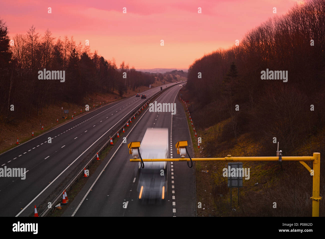 lorry passing average speed cameras at sunrise at roadworks leeds yorkshire united kingdom Stock Photo