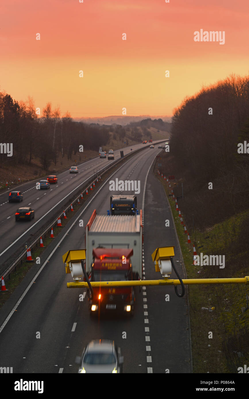 lorry passing average speed cameras at sunrise at roadworks leeds yorkshire united kingdom Stock Photo