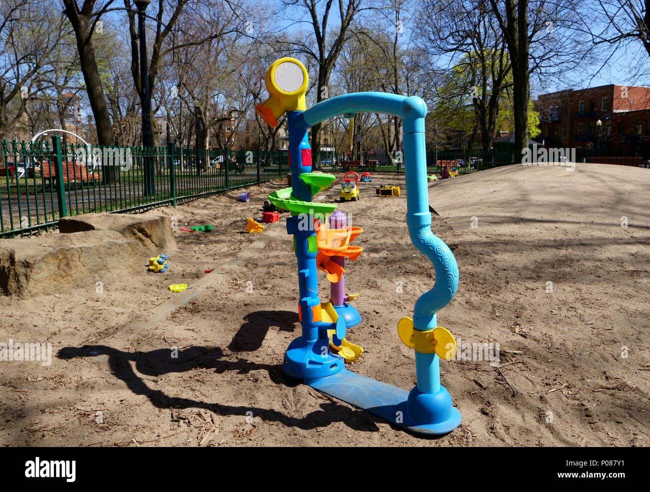 Playground in public park with a lot of colorful public toys abandonned by children. Stock Photo