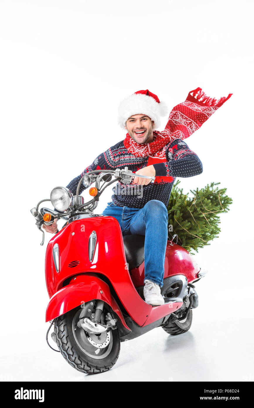 excited man in santa hat and scarf riding red scooter with christmas tree,  isolated on white Stock Photo - Alamy