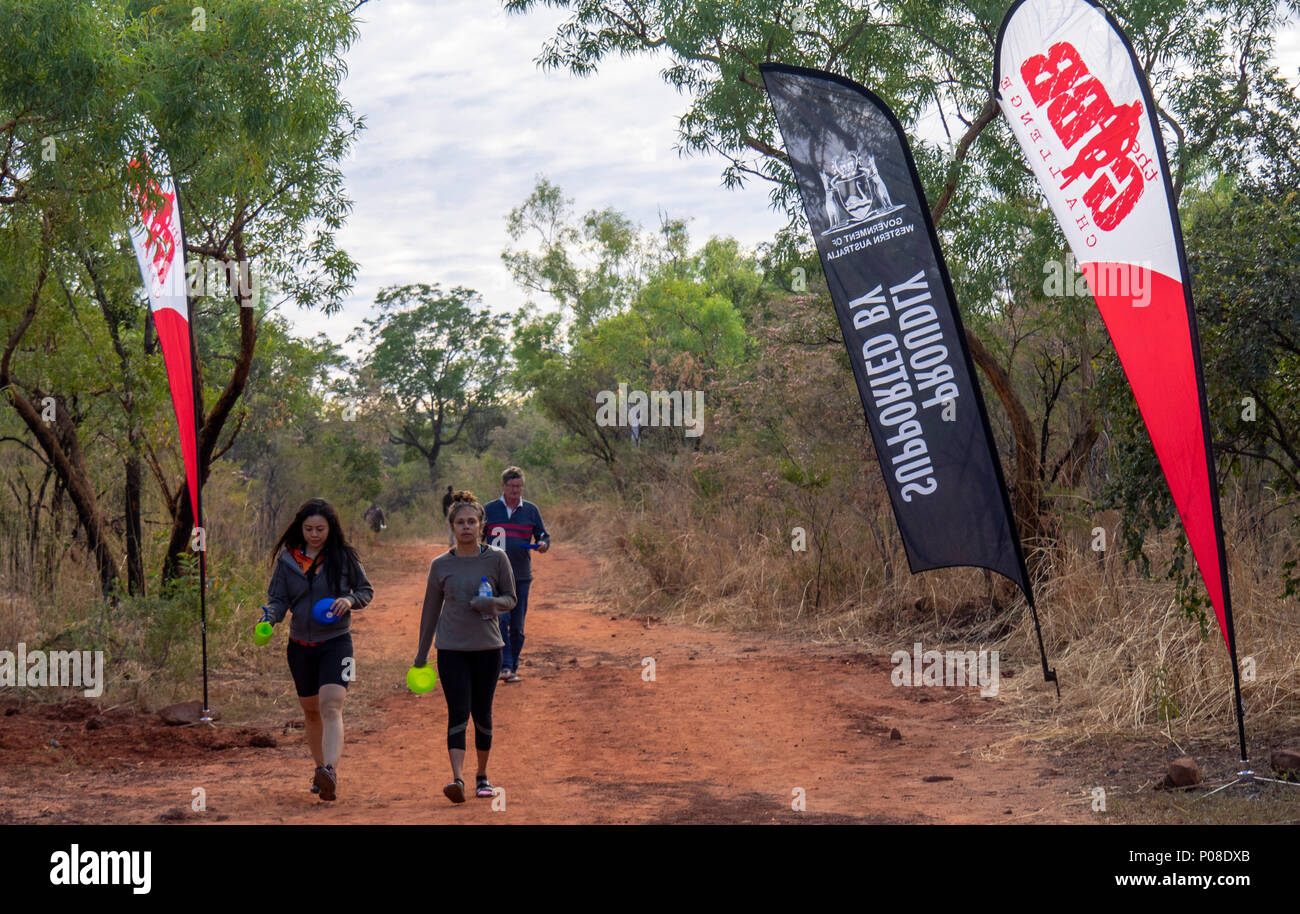 Gibb Challenge 2018 two indigenous women and a Caucasian male walking on a pindan dirt road Kimberley WA Australia. Stock Photo