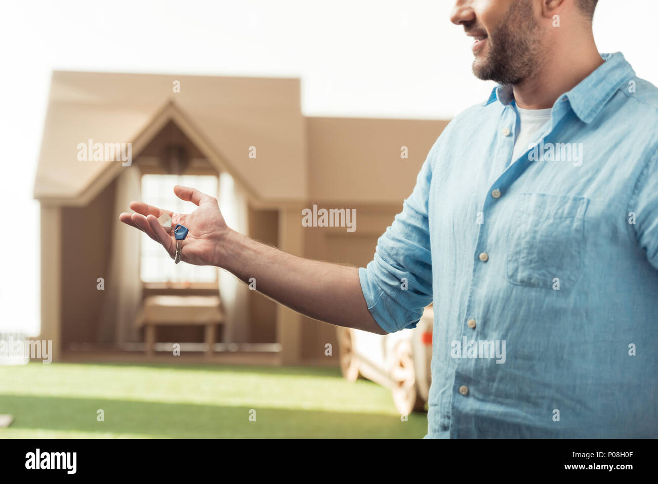 happy man holding key of new cardboard house isolated on white Stock ...