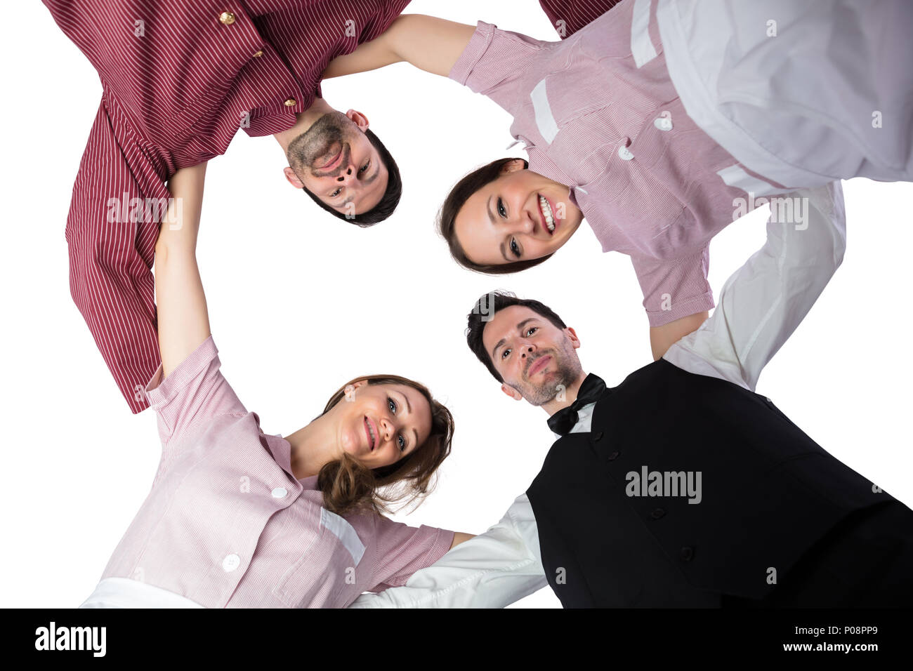 Young Hotel Staff Forming Huddle On White Background Stock Photo Alamy