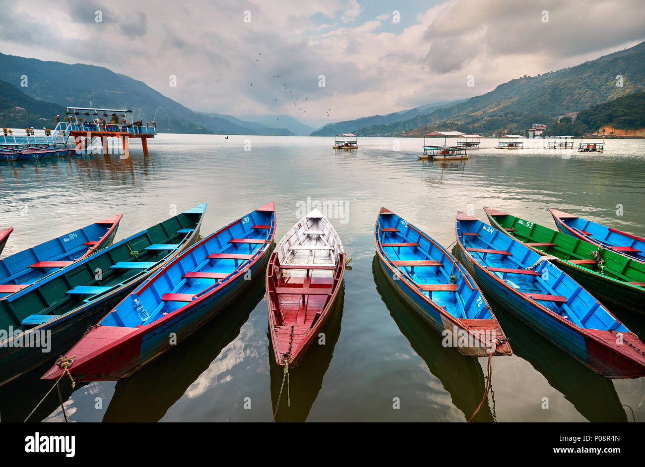 Color boats at Phewa lake shore in Pokhara, Nepal. Stock Photo