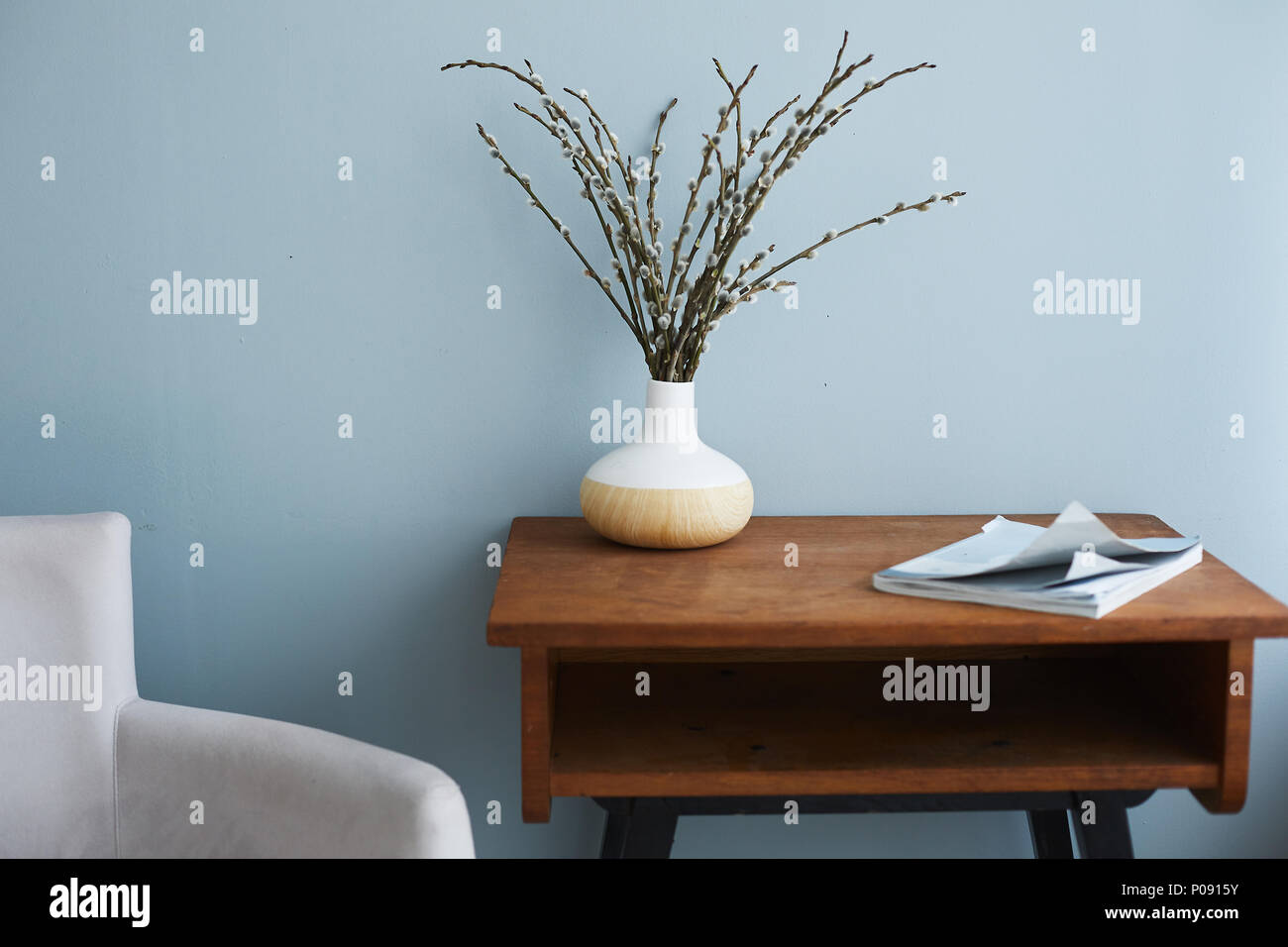 Modern Living Room Interior Armchair By A Side And Wooden Table With Vase And Fashion Magazine On It Stock Photo Alamy