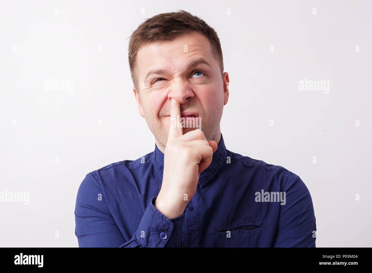 studio portrait caucasian man finger in nose Stock Photo