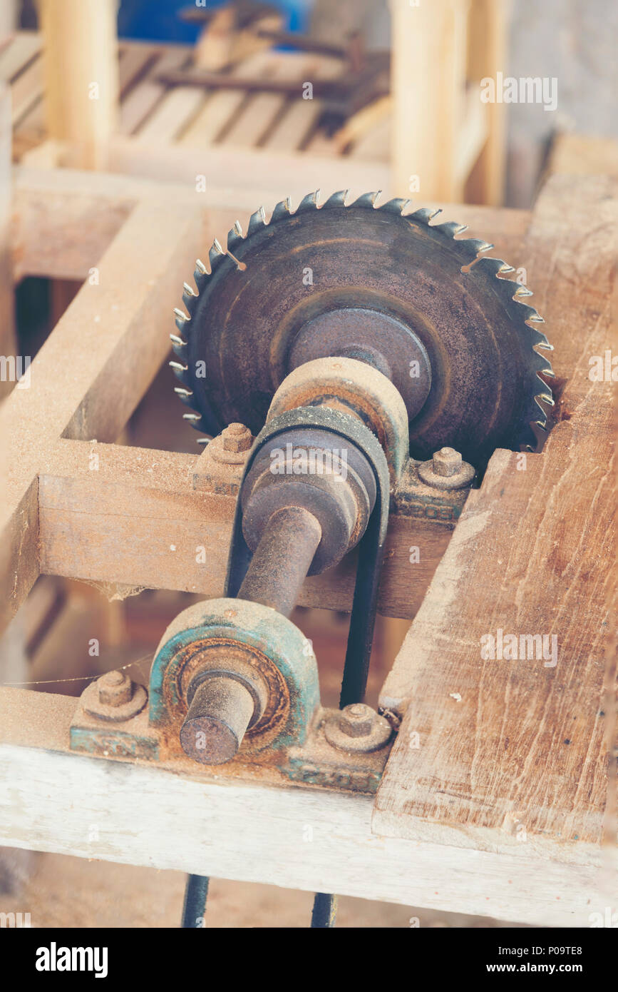 Carpenter cutting flaxboard using sliding compound mitre saw Stock Photo