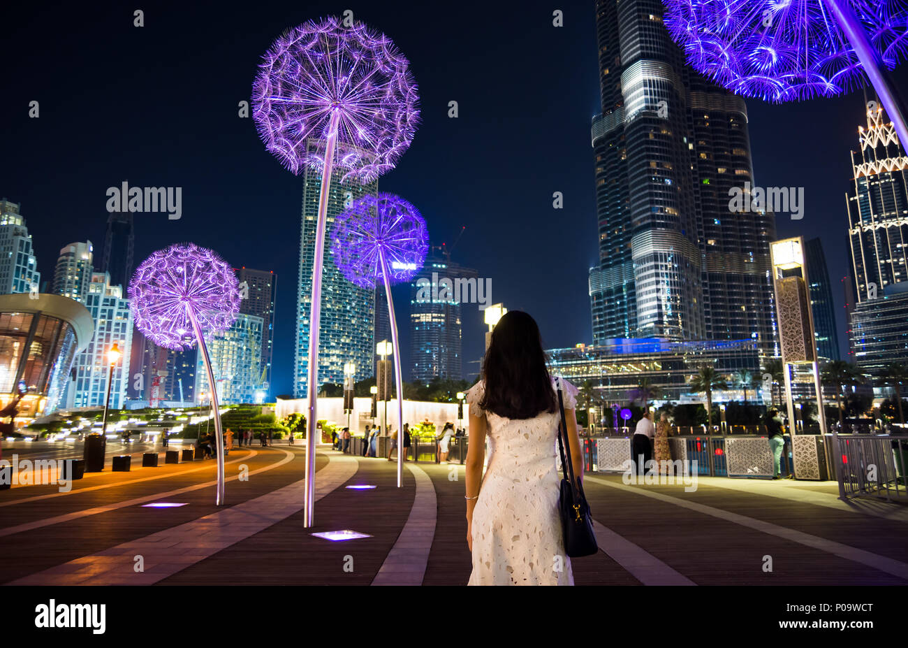 Girl having a walk in downtown Dubai at night Stock Photo