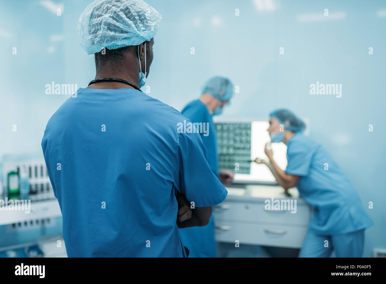 rear view of multicultural doctors looking at patient x-ray Stock Photo ...