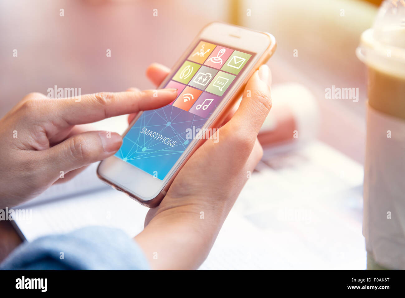 closeup woman hand using smartphone and flat icon app content on screen Stock Photo