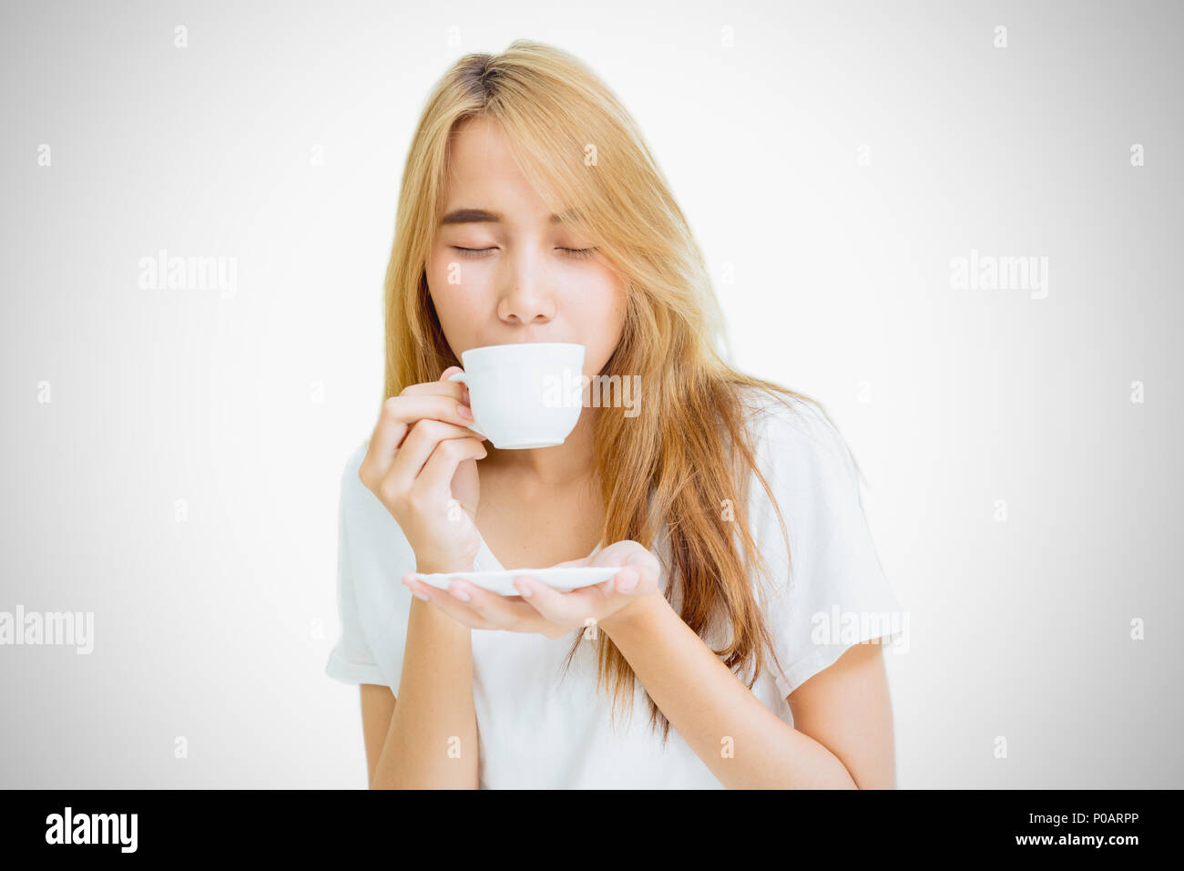 girl teen holding coffee cup to drinking coffee on white background Stock Photo