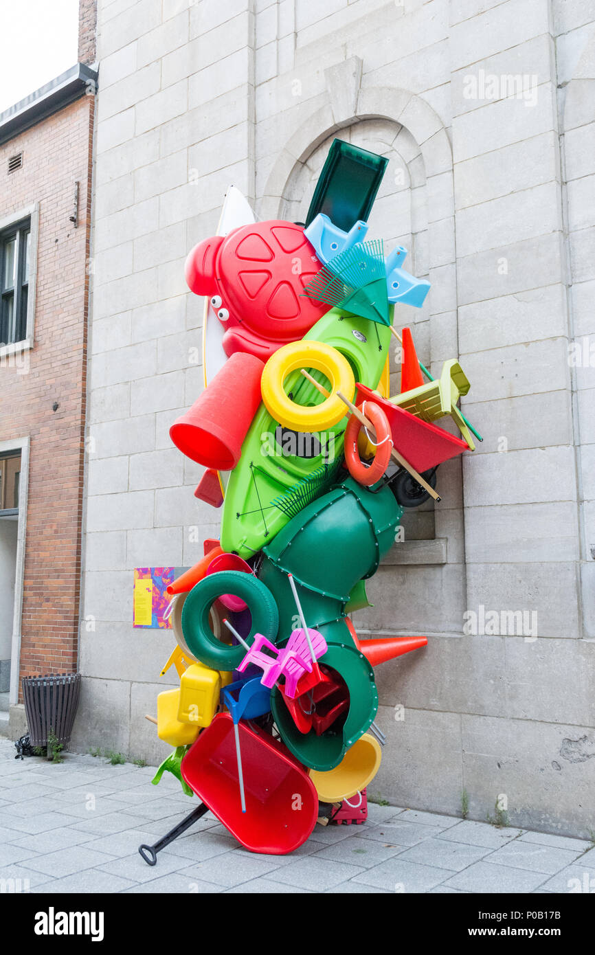 Bright colourful sculpture constructed from plastic toys, wheelbarrow, kayak as an example of street art in Quebec City, Quebec, Canada Stock Photo
