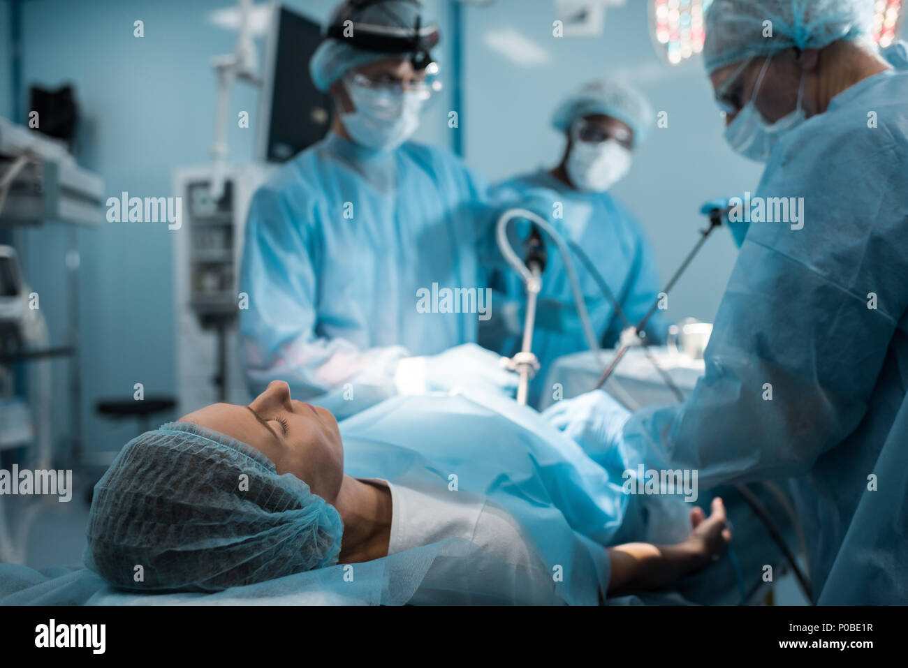 multiethnic surgeons operating patient in operating room Stock Photo ...